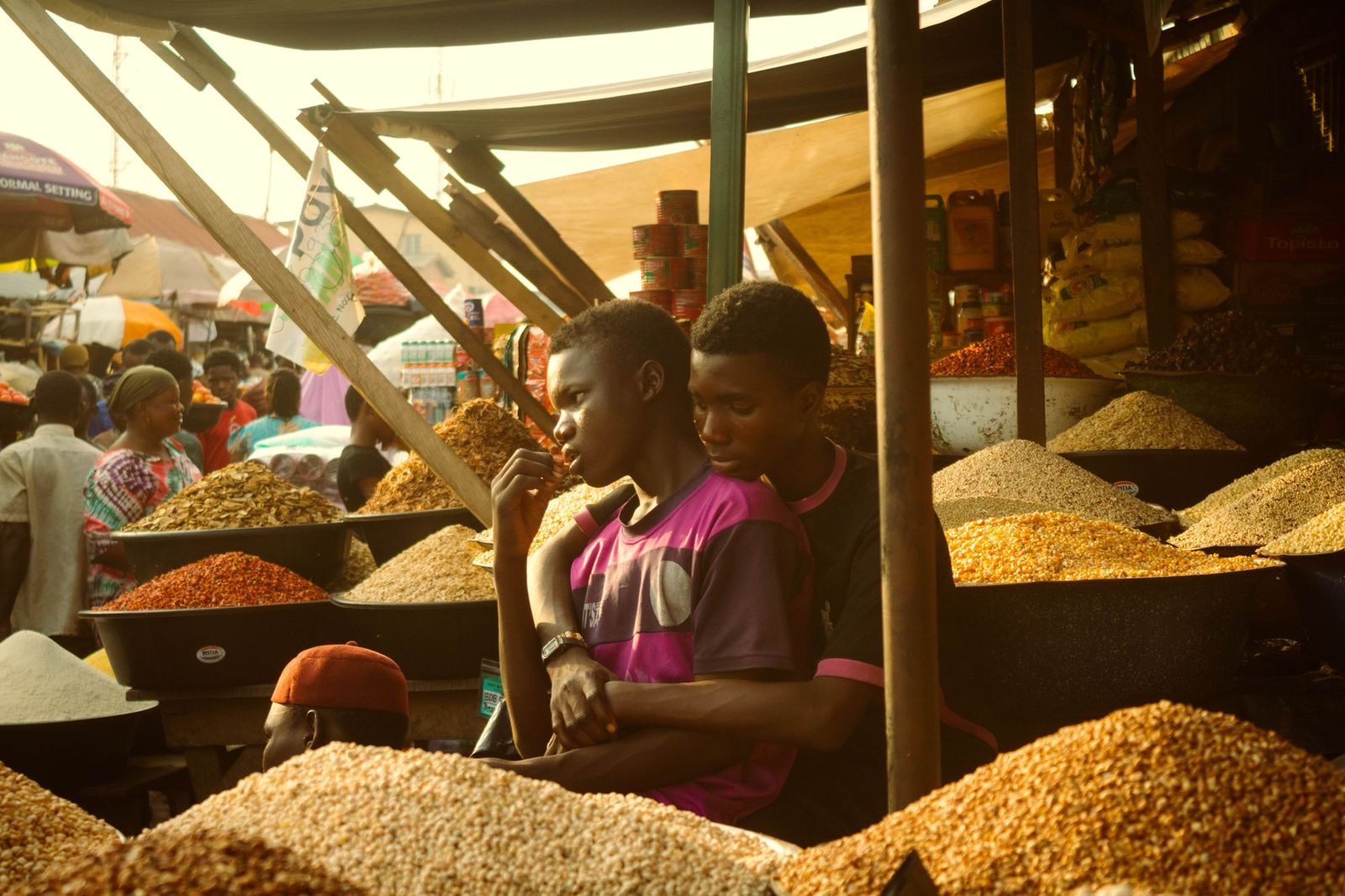 Traders among colourful grains in a Lagos market